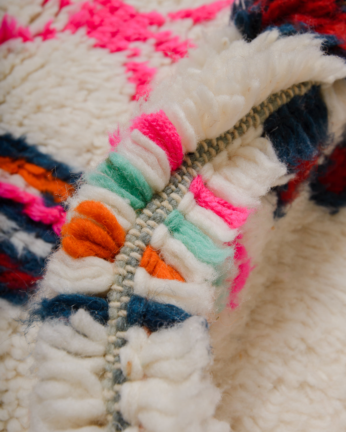 Detail of wool berber rug showing depth of pile and different coloured wool used.